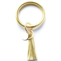 Close-up of golden PU leather bangle keychain with tassel pendant and round metal tag - Gold
