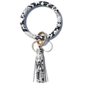 Close-up of black and white snakeskin PU leather bangle keychain with golden ring and tassel - White Snake Skin