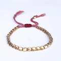 Detail of adjustable woven cord bracelet with matte gold irregular copper beads and tassels - Matte Finish