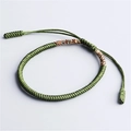 Adjustable green woven knot bracelet with colorful braided details on a white background - Multicolor Green
