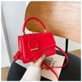 Chic red faux leather crossbody bag with a large golden square buckle and top handle - Red