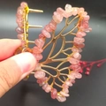 Close-up of golden butterfly hair claw clip with pink natural crystal gravel stones - Strawberry Quartz Gold Butterfly