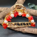 Golden hair claw clip with natural purple crystals and white pearls on dark background - Red Agate + Deep Sea Pearl Gold