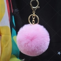 Detailed view of pink faux rabbit fur keychain with a gold metal ring and chain attachment - Deep Pink