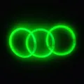 Three glowing green glow sticks connected in a circular bracelet shape on dark background - Green