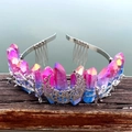 Detailed view of pink blue crystal crown with silver moon and metal combs on wood - Purple Blue
