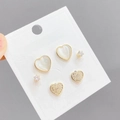 Detail of s925 silver needle earring set featuring cat eye hearts and zircon studs - Gold