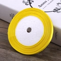 Bright yellow satin ribbon roll on a white foam core for gift wrapping and hair crafts - True Yellow