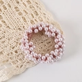 Close-up of light pink pearl hair tie on delicate lace fabric with soft lighting - OPP Bag / Pink