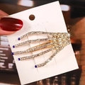Pince à cheveux main de squelette avec strass blancs et bleus sur base en métal doré - Main de Squelette Bleu Roi