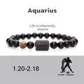 Macro shot of Aquarius matte black beads bracelet with golden spacers and zodiac charm - Aquarius