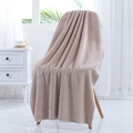 Absorbent beige coral fleece bath towel with elegant wavy scalloped edges on a chair - 70*140cm / Light Camel