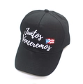Detail of black baseball cap featuring white Juntos Venceremos text and Puerto Rico flag - Juntos Venceremos