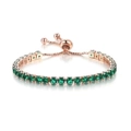 Detailed macro of 4mm green tennis bracelet with rose gold sliding bolo clasp - Rose Gold + Emerald