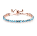 Rose gold adjustable bracelet featuring a single row of 4mm round light blue crystals - Rose Gold + Aquamarine Zirconia