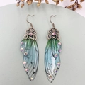 Detailed macro shot of translucent cicada wing earrings with green-blue gradient and rhinestones - Green Rhinestone-Bronze