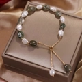 Detail of baroque freshwater pearl and green aventurine bracelet on silk background - Pearl Green Rutilated Quartz