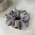 Close-up of premium grey satin scrunchie with silky texture and elegant folds - Light Gray