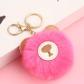 Detail of pink faux fur teddy bear keychain with golden metal clasp and fluffy texture - Watermelon red