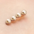 Elegant Korean style gold hair clip with four round pearls on a pink textured background - 4 Pearls Hair Clip