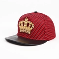 Detailed view of hip-hop snapback hat with gold crown emblem and red mesh fabric - Red