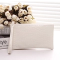 Fashionable white faux leather clutch bag with crocodile texture and wrist strap - Off White
