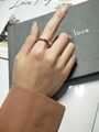 Detail shot of a silver adjustable wavy twisted ring on a finger with a clean background - Platinum