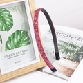 Detail shot of pink glitter headband with non-slip inner teeth on a rustic wooden background - Rose Pink