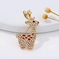 Golden reindeer brooch with white crystals and red enamel on a white ceramic plate - Cute Reindeer White