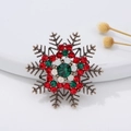 Festive snowflake brooch with red and green rhinestones on a vintage gold metal base - Gold Rhinestone Snowflake