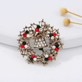 Christmas wreath brooch featuring gold plating with colorful rhinestones and bell detail - Bell