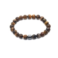 Detailed close-up of brown tiger eye beads and a cylindrical grey metal spacer bead - Tiger Eye with Single Magnetic Bead