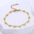 Detailed close-up of gold heart charms with blue evil eye enamel on adjustable chain - Yellow Eye