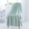 Soft thick coral fleece bath towel in mint green hanging on a wooden chair - 70*140cm / Bean Green