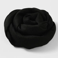 Solid black cotton linen scarf folded into a rose shape for elegant styling - Black