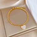 Gepolijste gouden kralenarmband met een sprankelende hartbedel in een luxe geschenkdoos - Goud