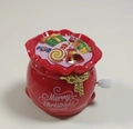 Wind-up red gift bag toy with Merry Christmas text and festive candy decorations - Wind-up Gift Bag
