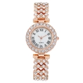 Close-up of rose gold luxury watch featuring crystal-encrusted bezel and Roman numerals - Rose Gold
