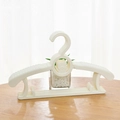 Stack of white adjustable baby clothes hangers with non-slip bear design and hooks - Bear Style-Beige