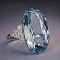 Exquisite cocktail ring featuring a large oval blue crystal with silver step-cut accents - US 7 / Blue
