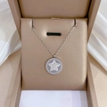 Close-up of a silver star pendant necklace with cubic zirconia inlay in a beige jewelry box - Titanium Steel / Steel Color Star Round Tag Necklace (K424)