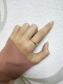 Close-up of adjustable irregular gold twist wave ring worn on woman finger - Gold