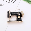 Detailed macro view of a vintage sewing machine brooch with black enamel and gold crown - 20# Black Sewing Machine