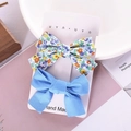 Floral and solid blue fabric bow hair clips set displayed on a stylish pink tabletop - Blue Floral Set