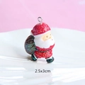 Macro view of Santa Claus resin pendant with glitter finish and size dimensions 2.5x3cm - Style 12-Santa with Gift Bag