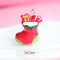 Macro shot of 3x2.5cm red and green resin Christmas stocking pendant with metal loop - Style 28-Red and Green Stocking