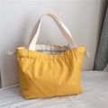 Minimalist yellow canvas drawstring handbag with white handles and durable fabric - Dark Yellow