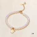 Detailed macro view of white freshwater pearls with a gold Fu character heart charm - Fu Character Pendant Style (B1119 3#) / White/Gold
