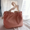 Close-up of pink canvas tote bag with drawstring closure and cream-colored handles - Coral Pink
