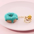 Handmade crochet donut keychain in teal and beige with a small golden bell - Donut-Green